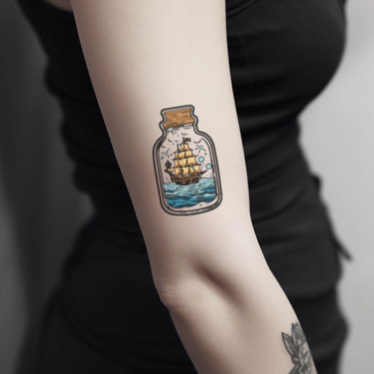 best cool simple small black pirate ship in a bottle ocean wave color illustrative traditional fake realistic temporary tattoo artwork sticker design idea drawing for men and women on bicep upper arm