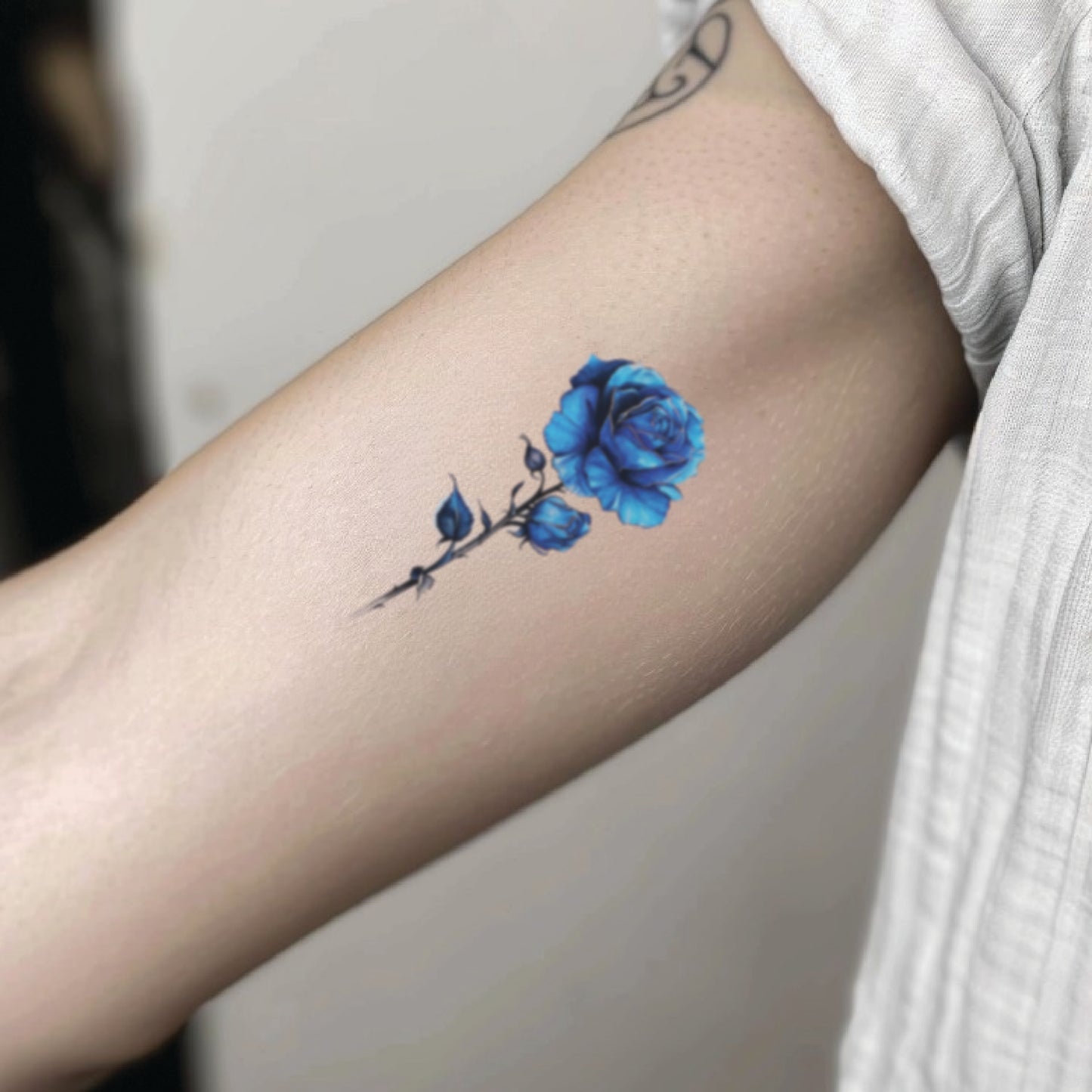 best cool simple small blue color rose flower floral fake realistic temporary tattoo sticker design idea drawing for men and women on bicep upper inner arm