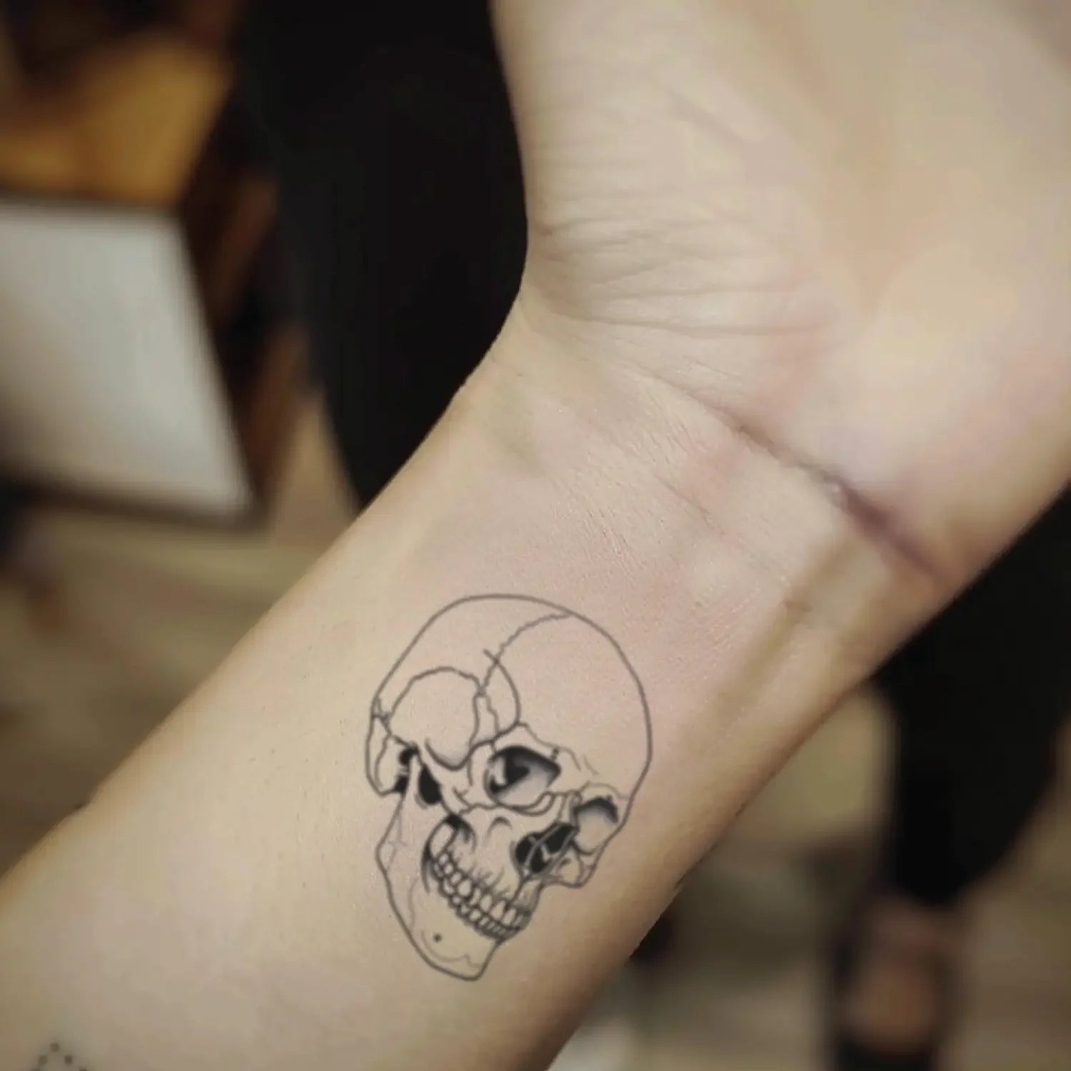 best cool simple small black color skull outline fake realistic temporary tattoo sticker design idea drawing for men and women on wrist