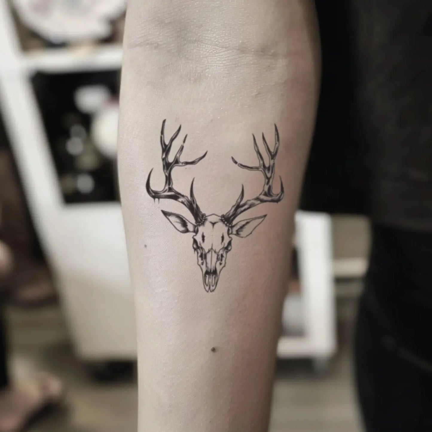 best cool simple small black color deer animal skull fake realistic temporary tattoo sticker design idea drawing for men and women on forearm lower inner arm