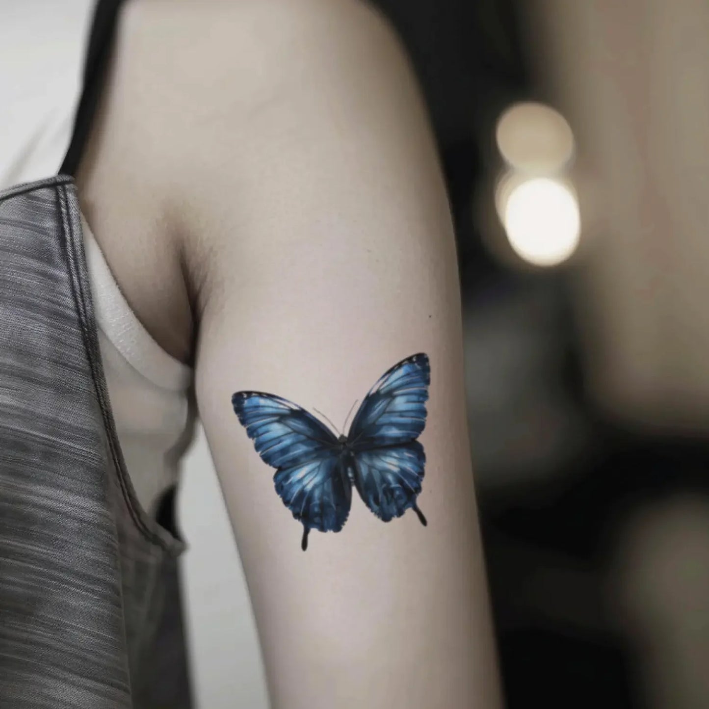 best cool simple small black dark blue color butterfly fake realistic temporary tattoo sticker design idea drawing for men and women on bicep upper arm