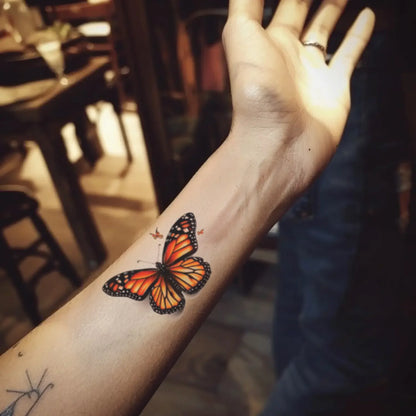 best cool simple small black orange color realistic butterfly fake realistic temporary tattoo sticker design idea drawing for men and women on forearm lower arm